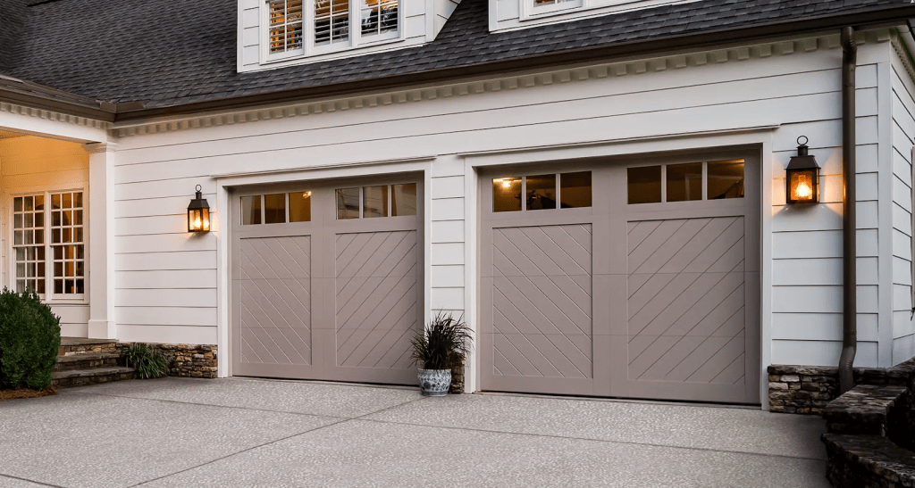 Modern suburban home exterior with two beige garage doors